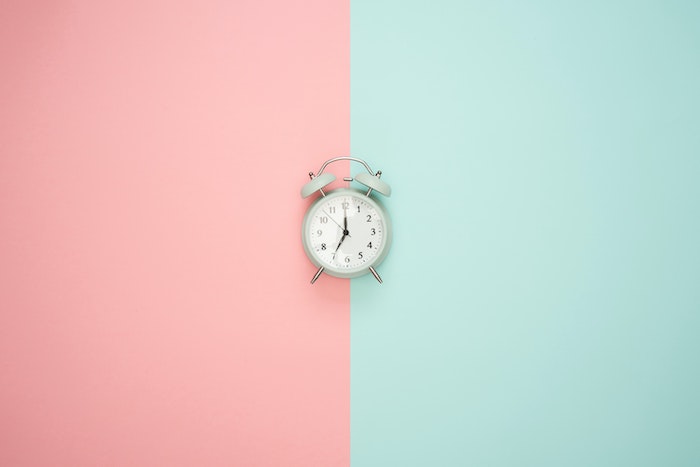 blue and pink graphic with an alarm clock