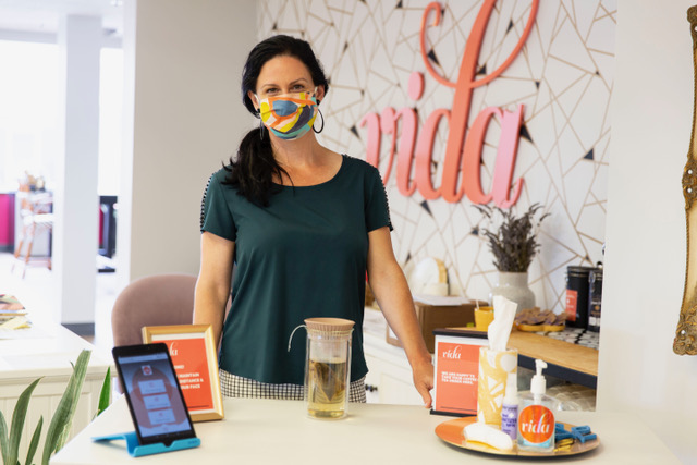 staff member wearing a mask at the office reception at vida coworking in portland oregon