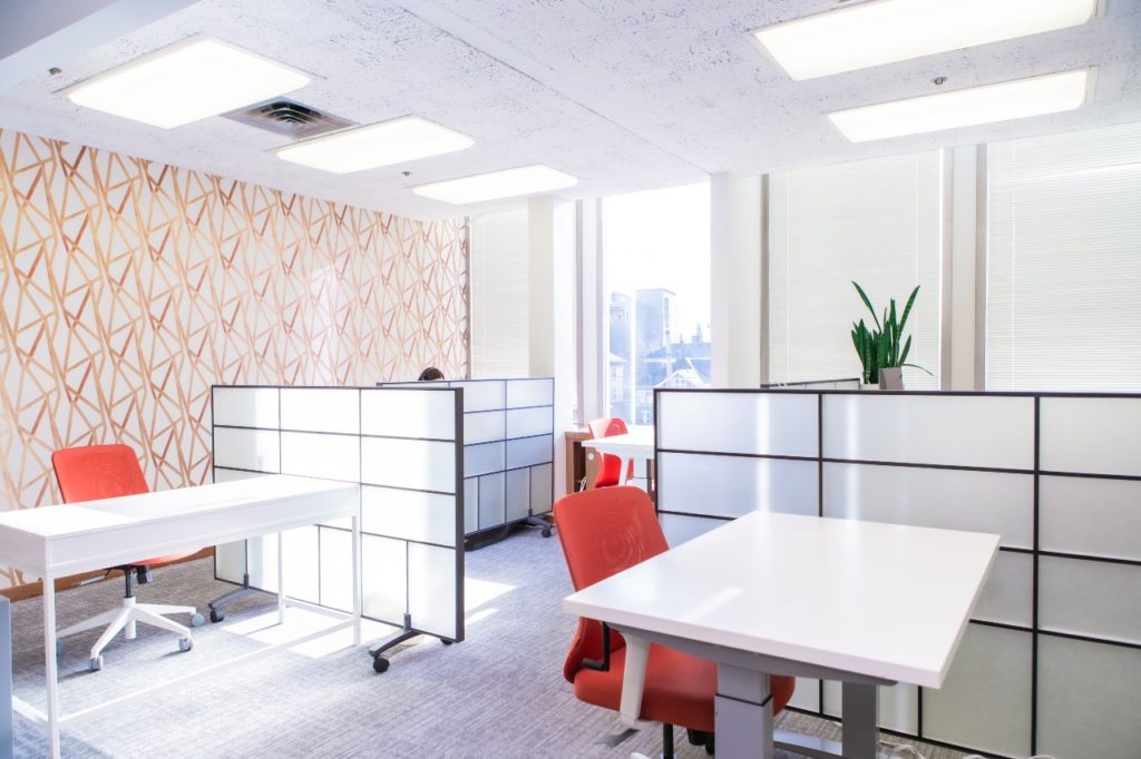 socially distanced dedicated desks and privacy partitions at vida coworking in portland