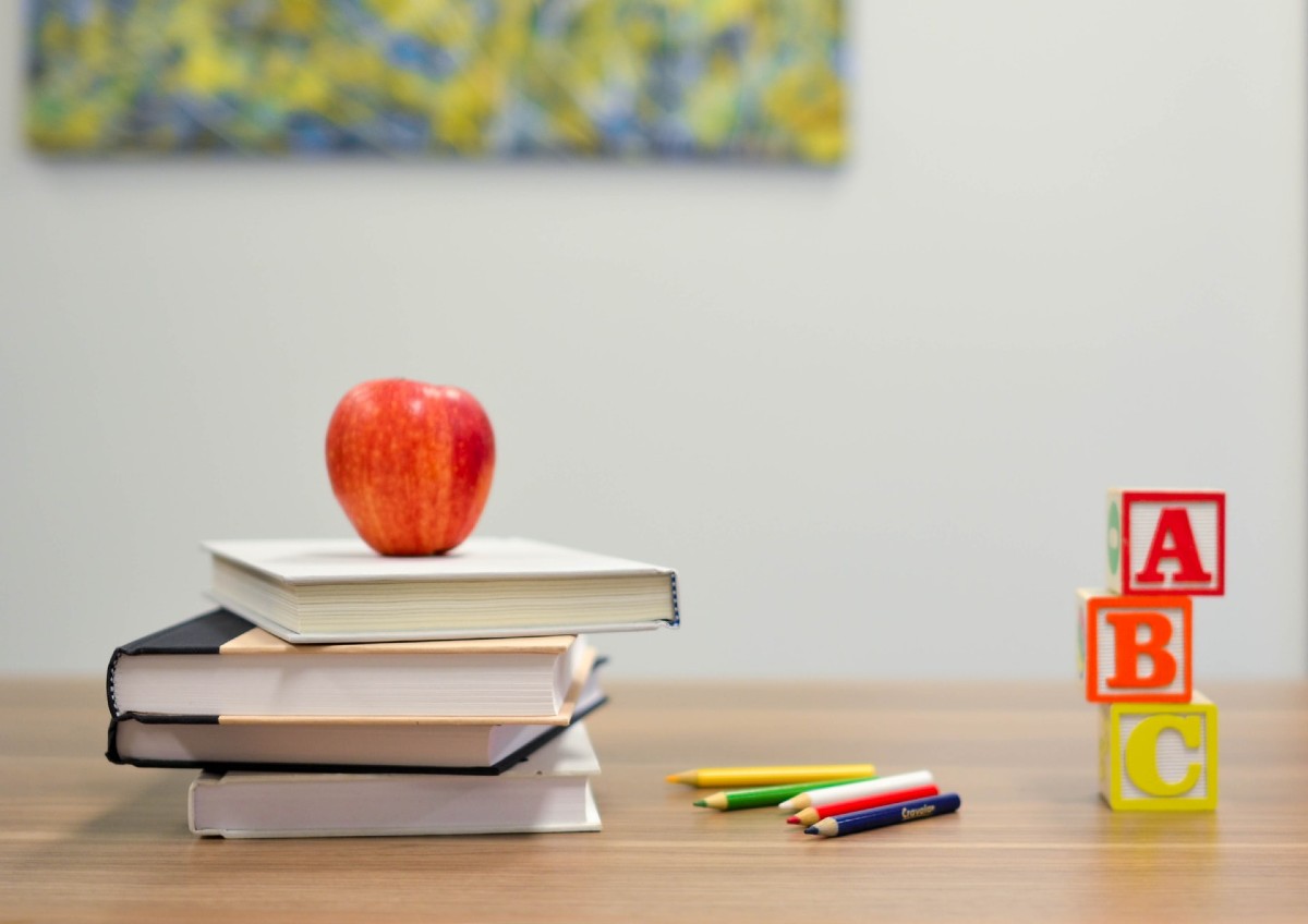 a stack of books, blocks and colored pencils in a school