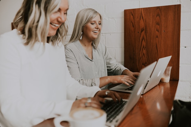 two women working together in a coworking office space