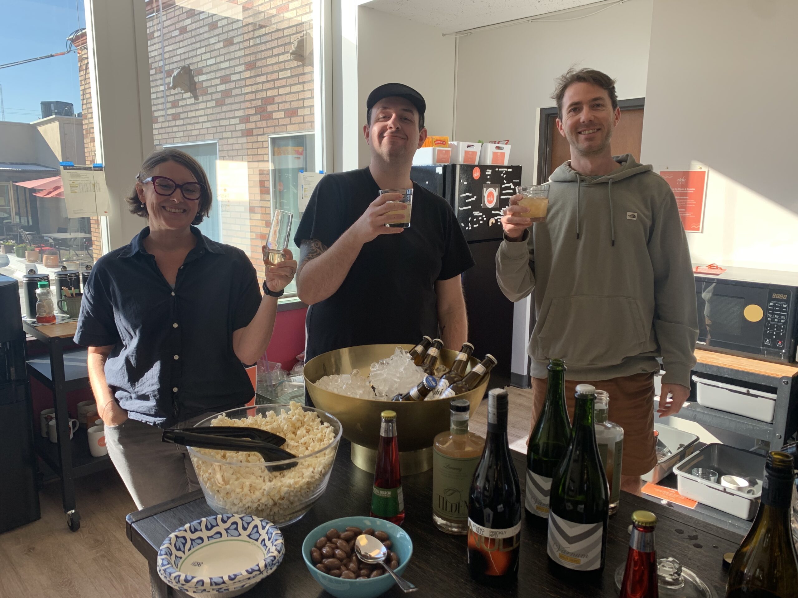 Three people standing in the VIDA NE snack and drink area