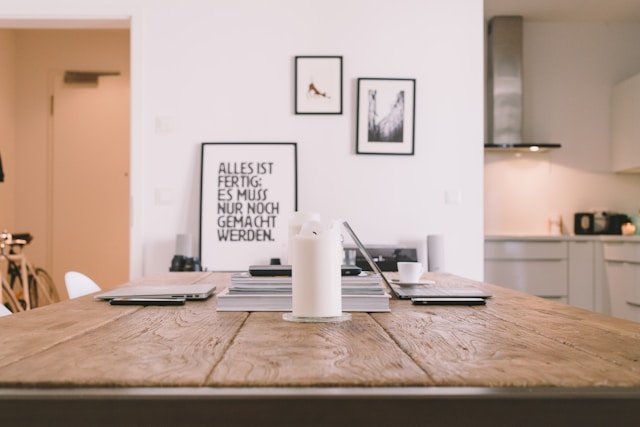 a kitchen table with a computer set up on it for work