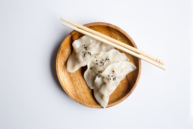 a plate with 3 dumplings on it