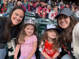 Two women with their children at a Portland Thorns game
