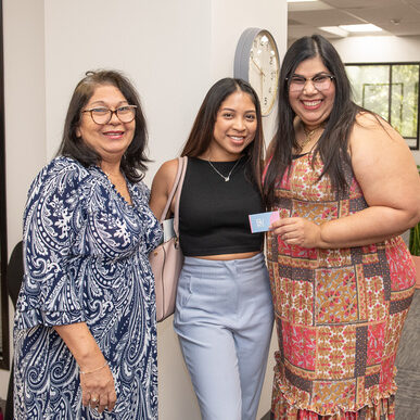 Three BIPOC women smiling