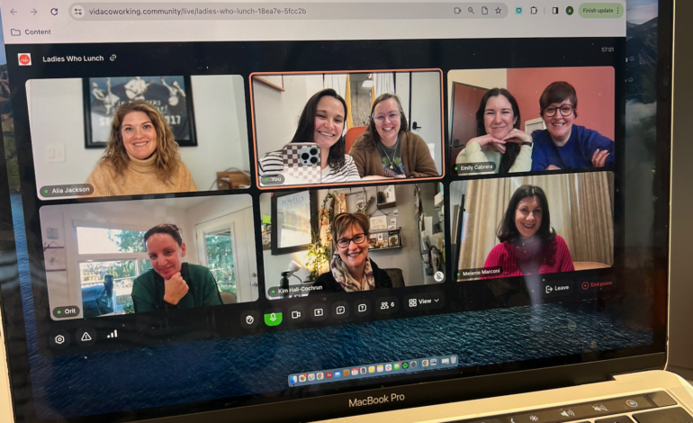A laptop screen with a video call on it featuring 6 different participants