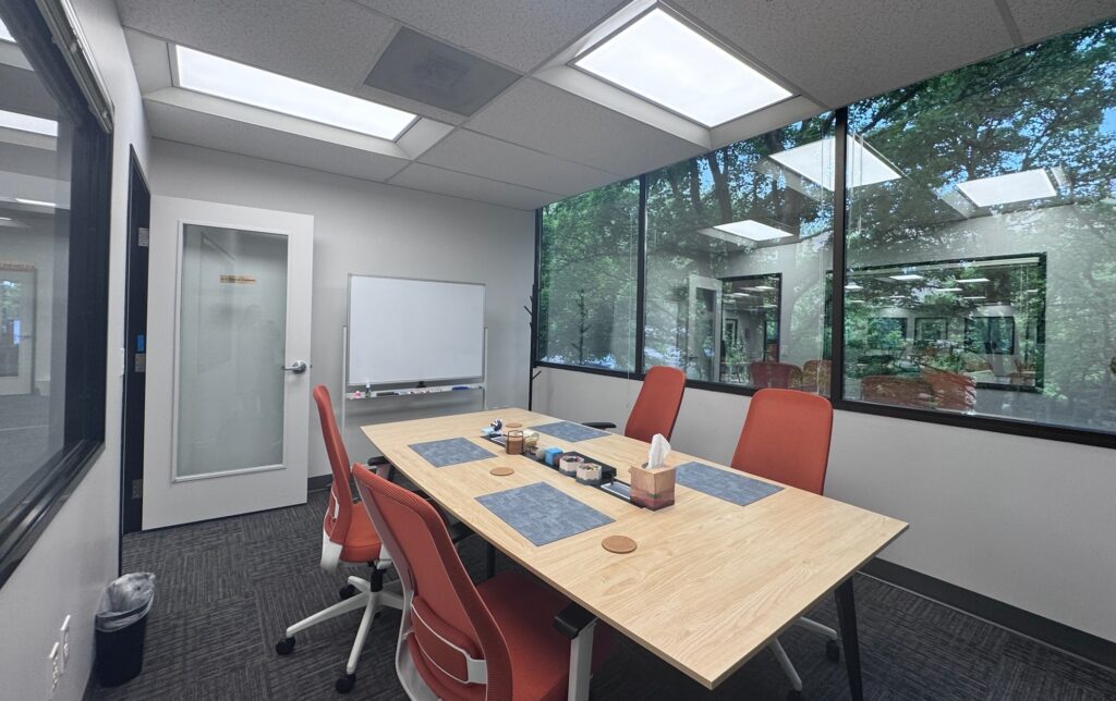 An intimate conference room with seating for 4 people